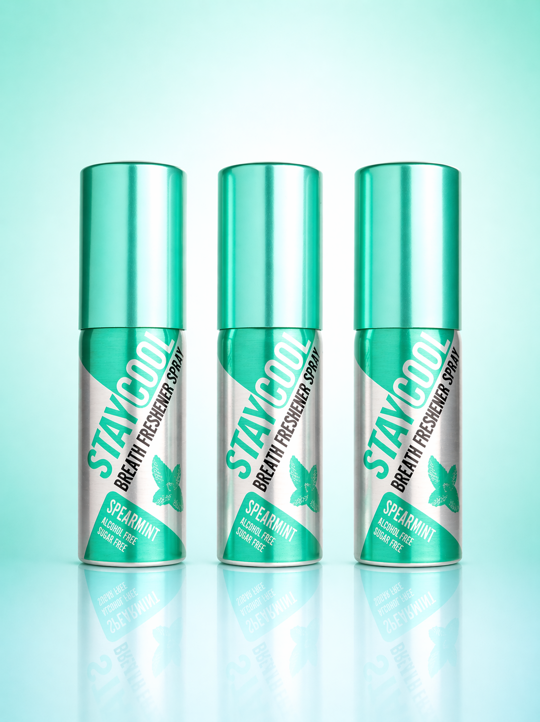 Three 'STAY COOL' breath freshener spray cans on a gradient green background