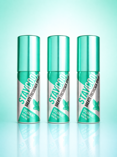 Three 'STAY COOL' breath freshener spray cans on a gradient green background